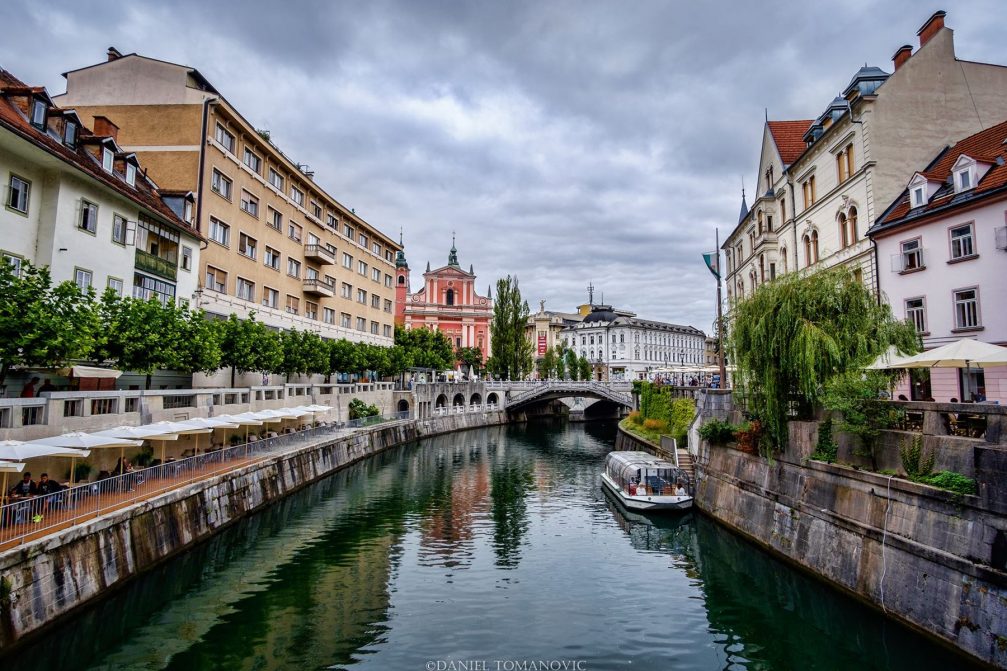 The Ljubljanica River flowing through Ljubljana's Old Town in the summer