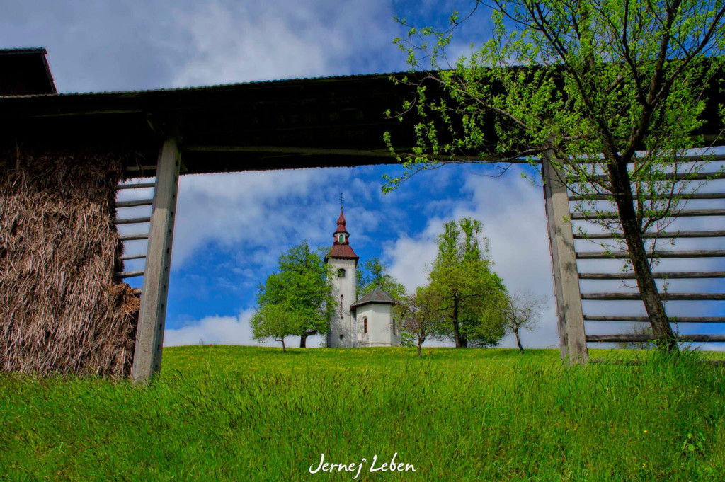 Hayracks and churches are a distinct feature of the Slovenian landscape