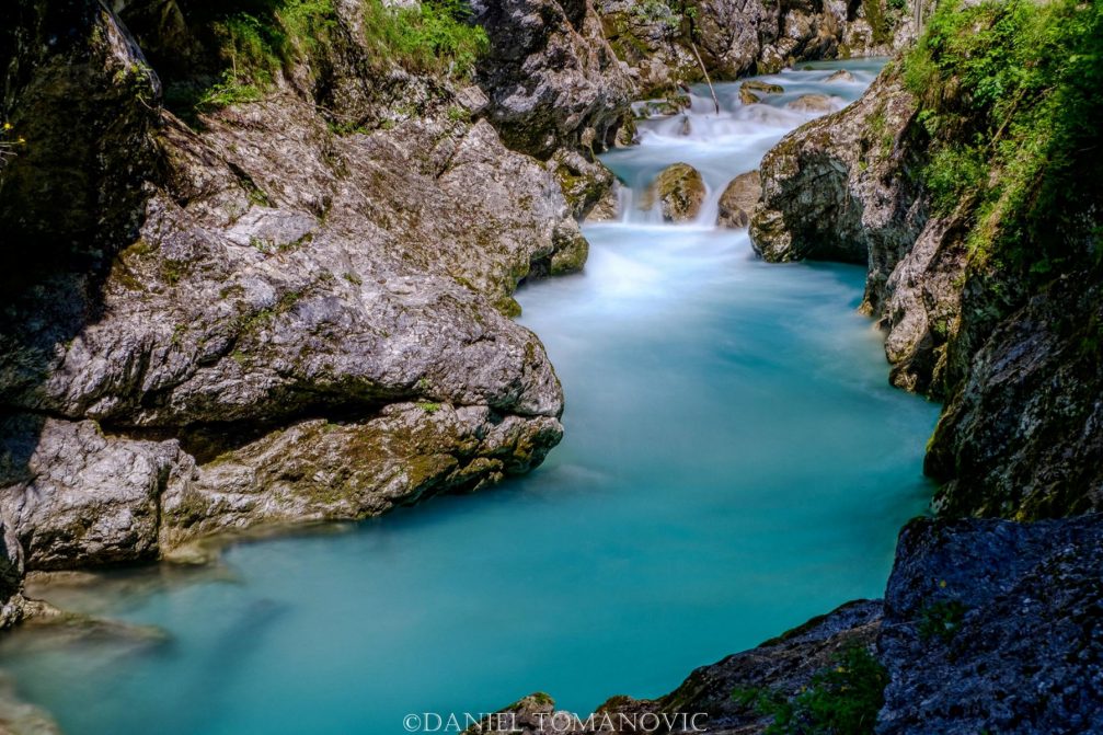 The crystal-cear aquamarine water of the Tolminka river in the Tolmin Gorge