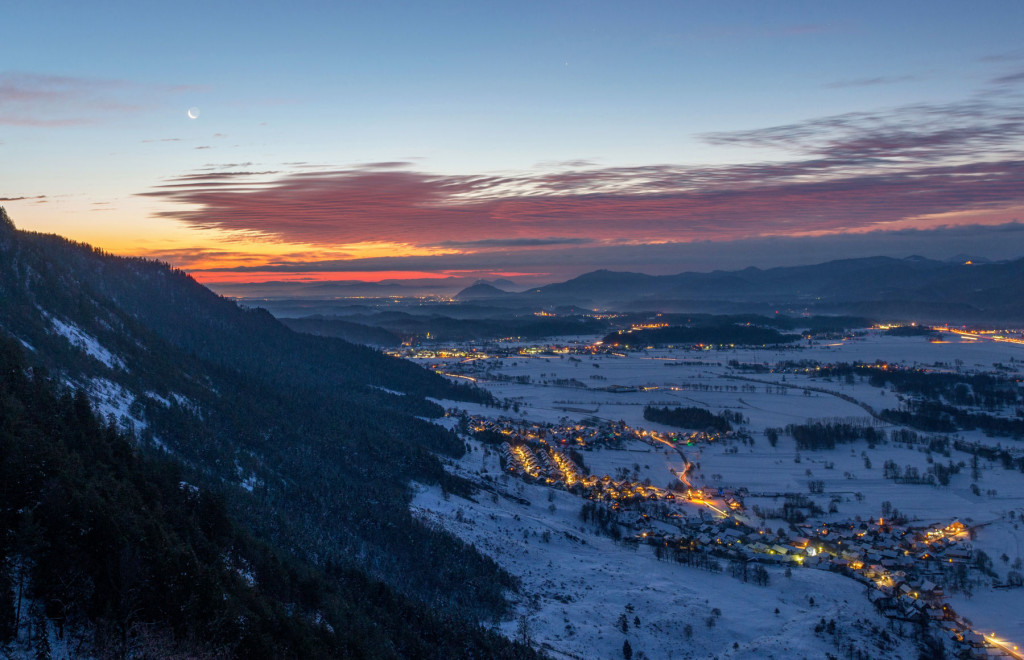 Villages in Slovenian Alps on an early winter morning, glowing in the snow