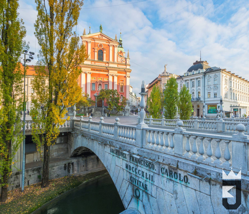 Triple Bridge in Ljubljana, the capital of Slovenia with the pink Franciscan church in the background