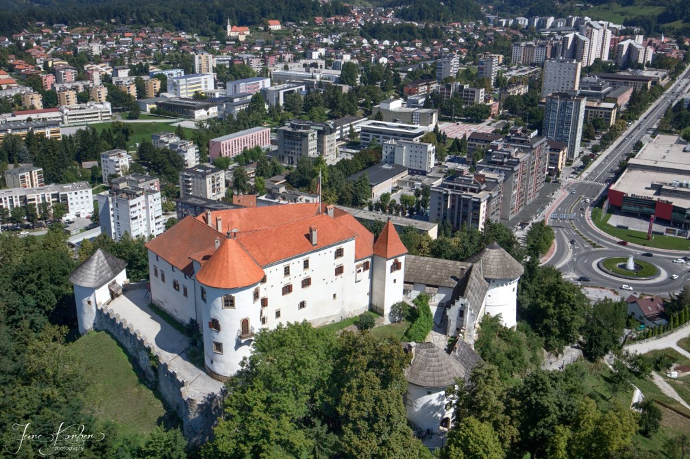Aerial view of Velenje, the fifth largest city in Slovenia with its beautiful white hilltop castle