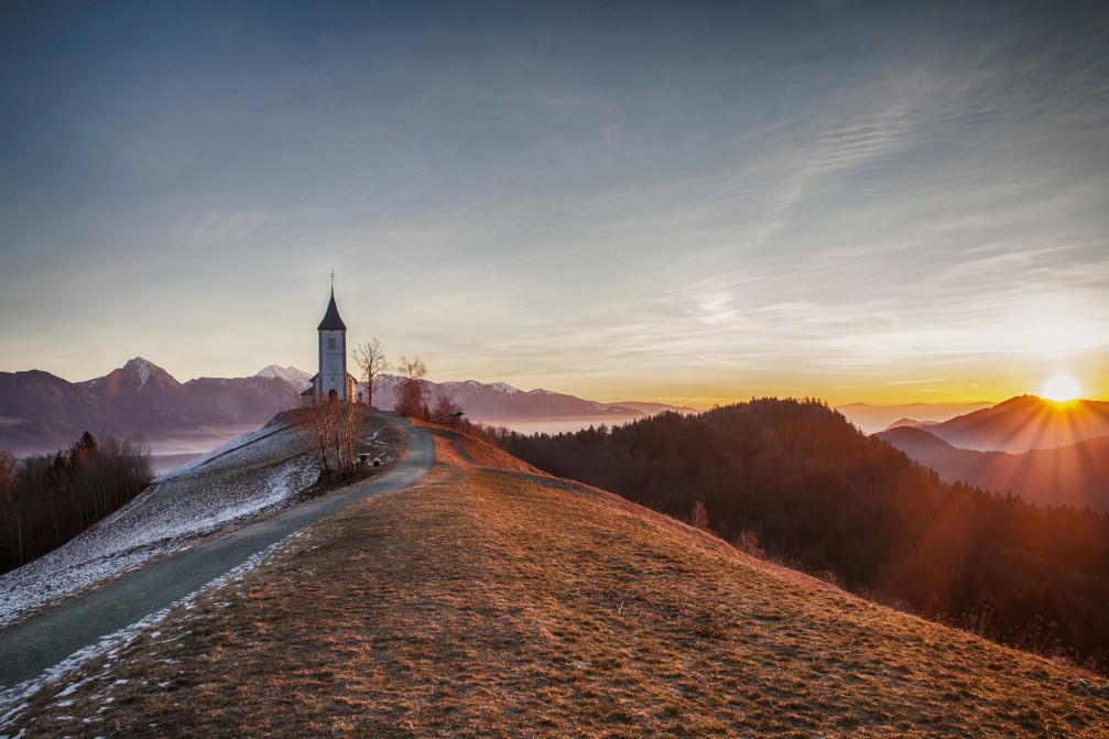 The Jamnik Church of Saints Primus and Felician and surrounding mountains of the Slovenian Alps