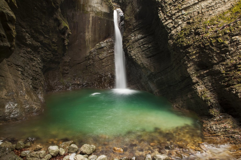 Kozjak waterfall falling 15 meters into an alluring pool nested between magnificent dark rocks