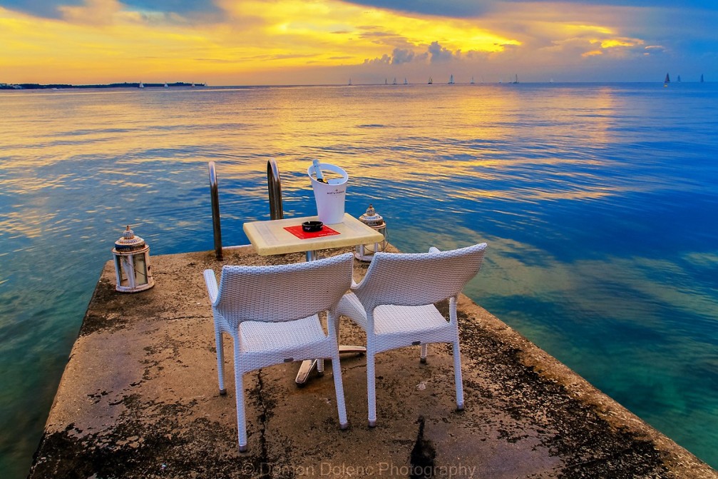 Perspective of a pier with a romantic restaurant table with an ocean view in Piran, Slovenia