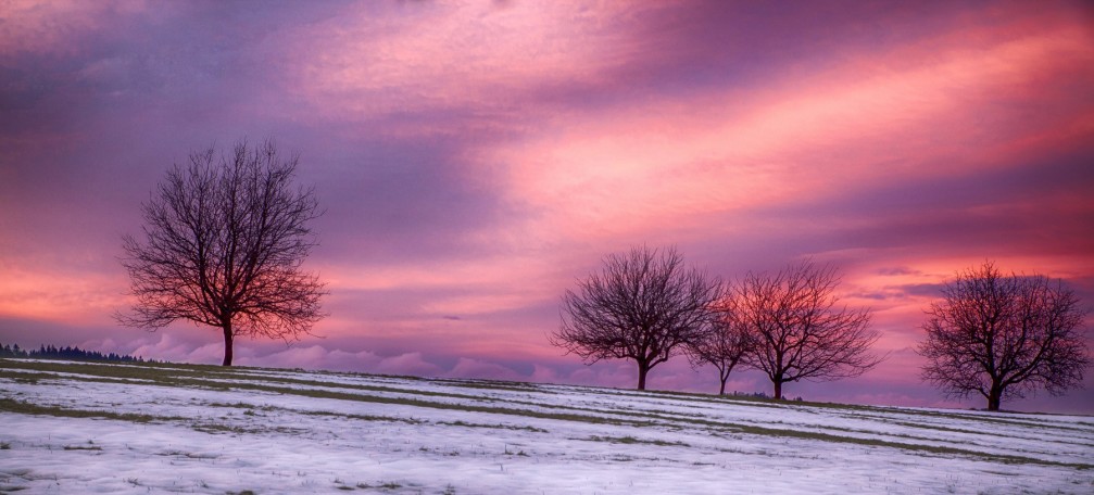 Spectacular winter sunset with vivid colors in shades of pink through purple near Velika Preska, Slovenia