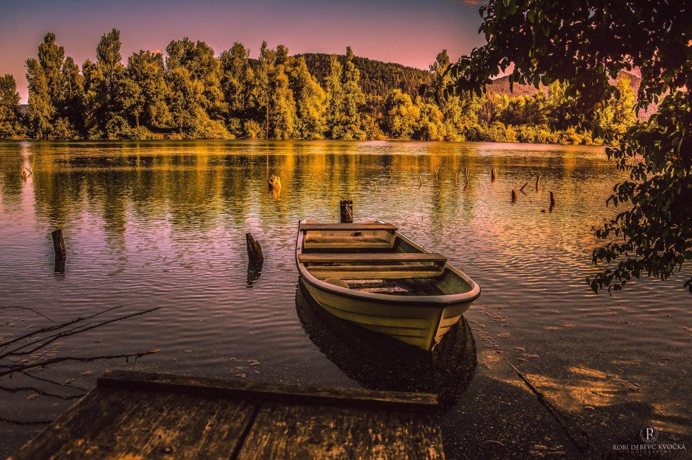 A small old boat on the shore of the Verd pond near the town of Vrhnika, Slovenia