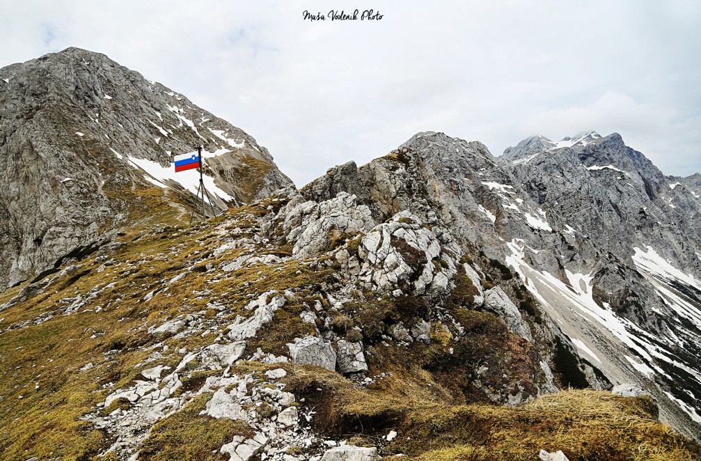Slovenian flag at the Kamnik saddle in the Kamnik-Savinja Alps, Slovenia
