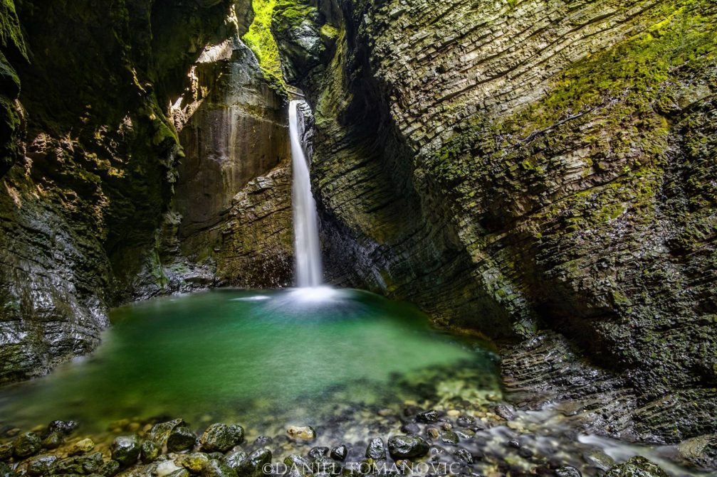 View of the Kozjak Waterfall with an emerald green pool at its base near Kobarid, Slovenia