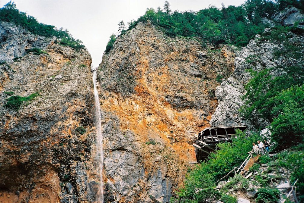 The Rinka waterfall in the Logar Valley with the Eagle’s Nest bar to the right