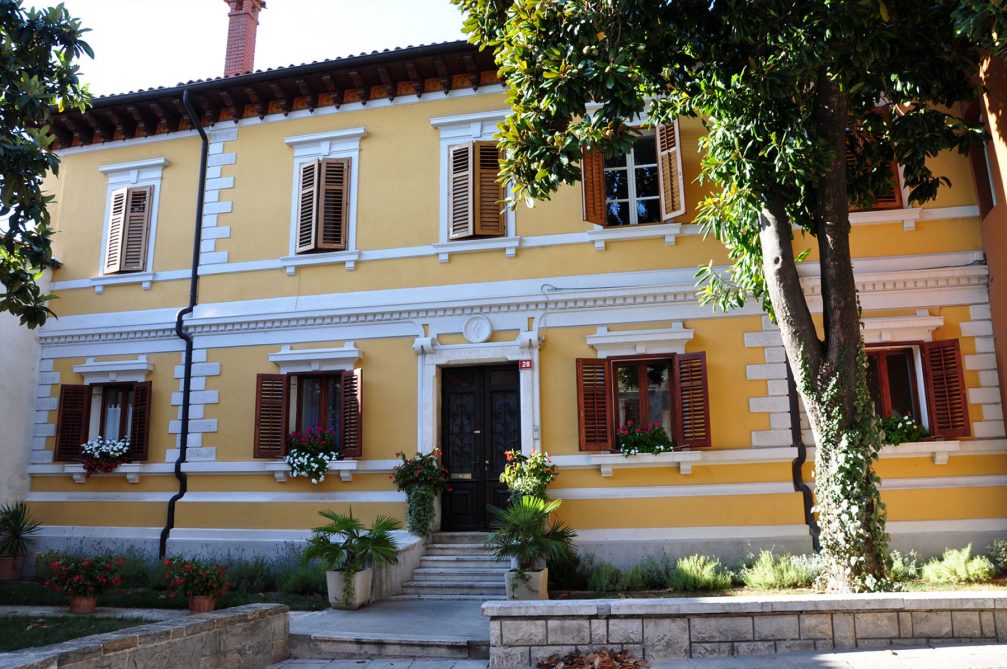 The picturesque yellow house in the Kidriceva Ulica street in Koper, Slovenia