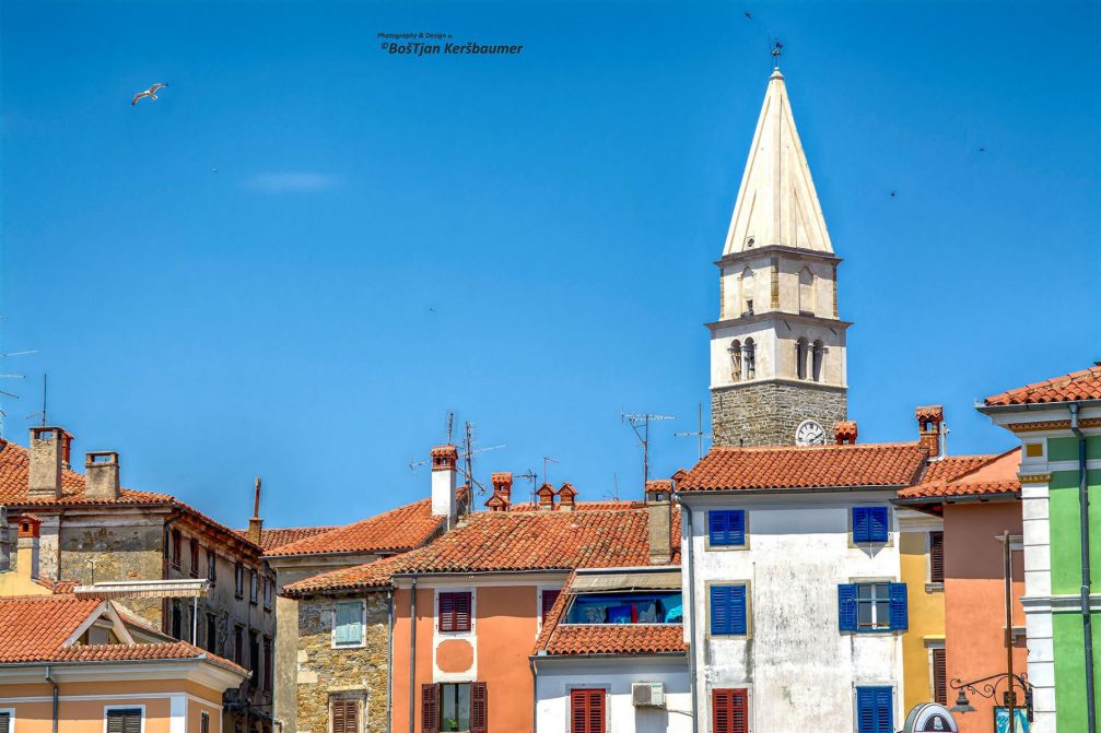 Well-preserved old buildings with red tile roofs in Izola, Slovenia