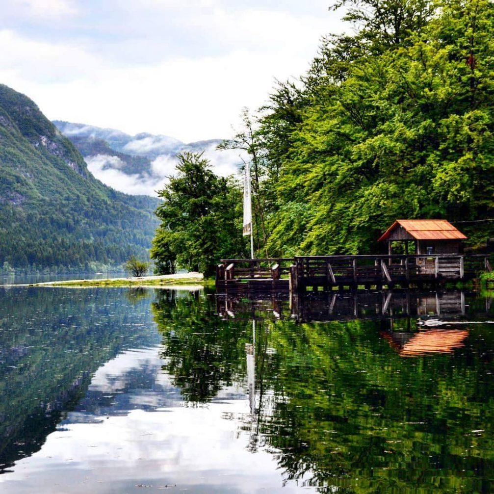 A beautiful view of Lake Bohinj with the reflection of the mountain on its surface