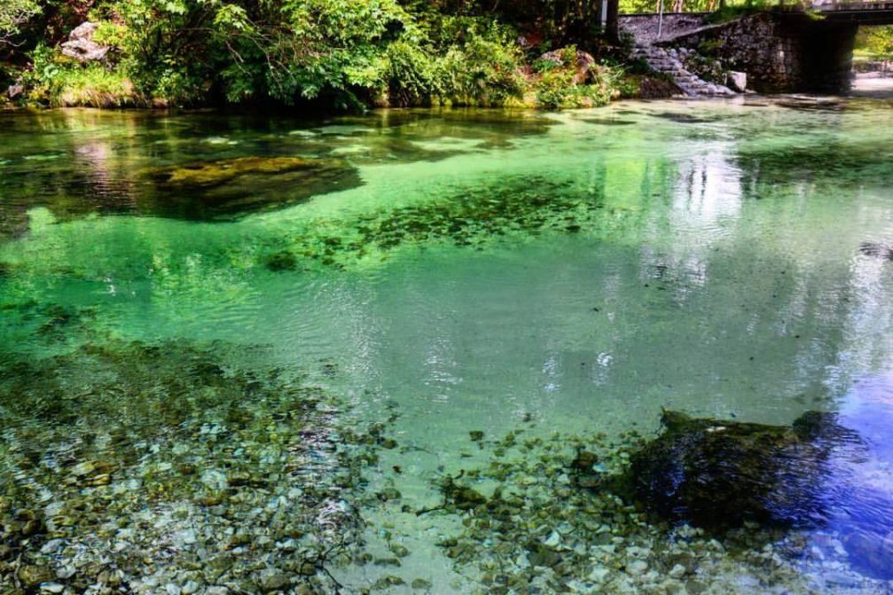 The crystal-clear turquoise water of the Savica stream in Ukanc near Lake Bohinj