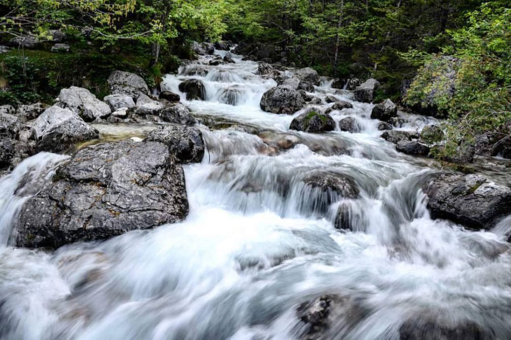 A crystal clear fresh mountain stream in the Trenta valley in the Triglav National Park