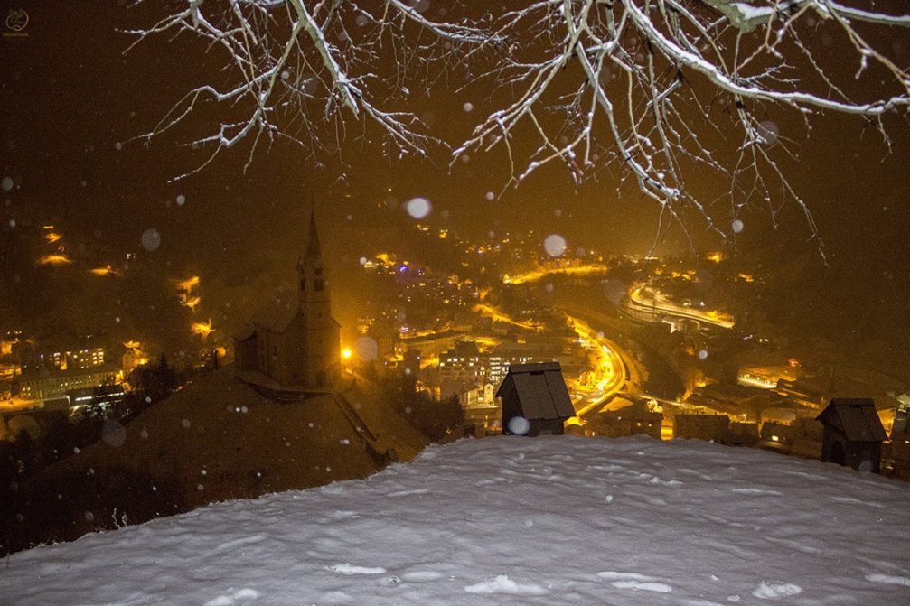 Elevated view of the town of Idrija in Slovenia on a snowy winter night