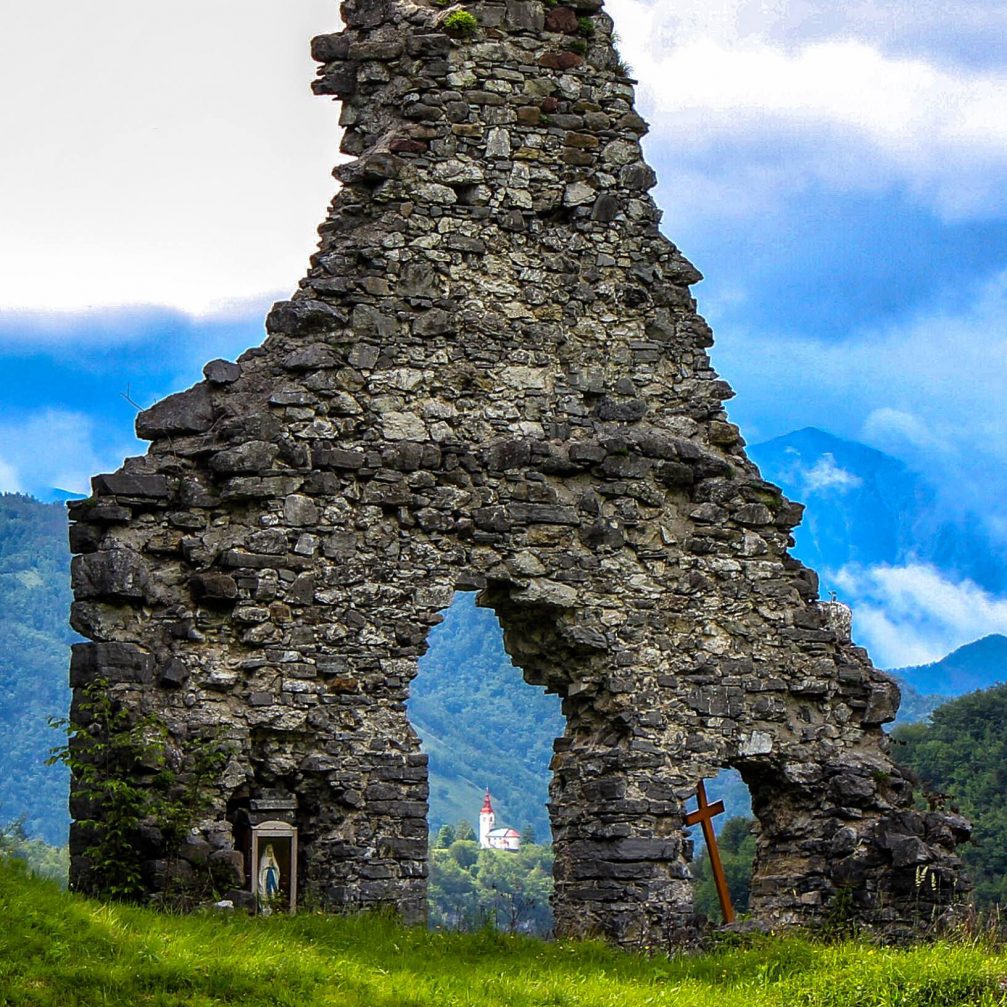 View of the local church in Sebrelje through the ruins of an old church in Jagrsce