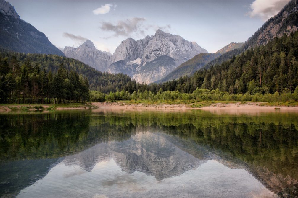 Lake Jasna with spectacular reflections of the surrounding mountains on a crystal clear surface