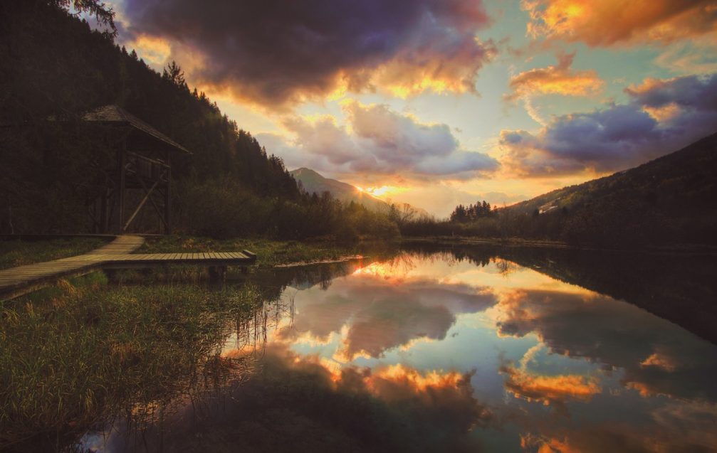 Lake Zelenci in the Zelenci Nature Reserve with dramatic reflections on a crystal clear surface