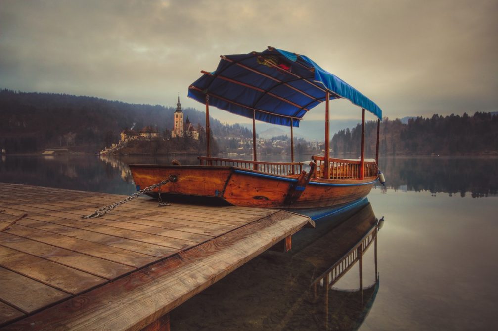 A traditional Slovenian Pletna boat on the shore of Lake Bled in Slovenia