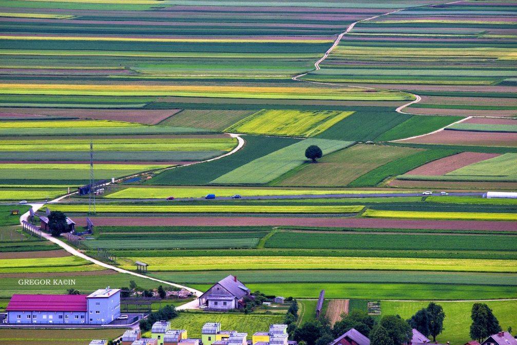 Elevated view of the picturesque Sorsko Polje fields near the village of Srednje Bitnje in Slovenia