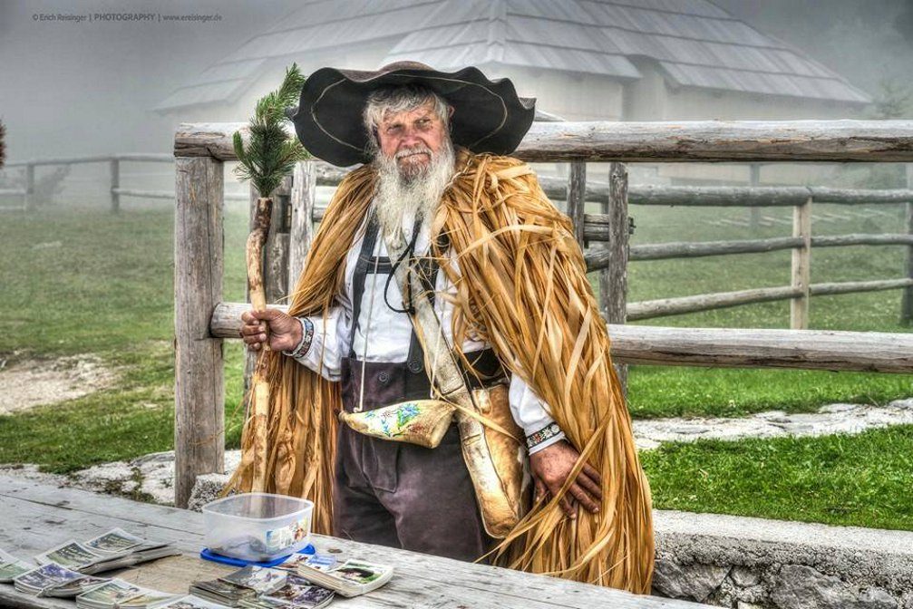 An older man wearing a traditional herdsman's costume on the Velika Planina plateau in Slovenia