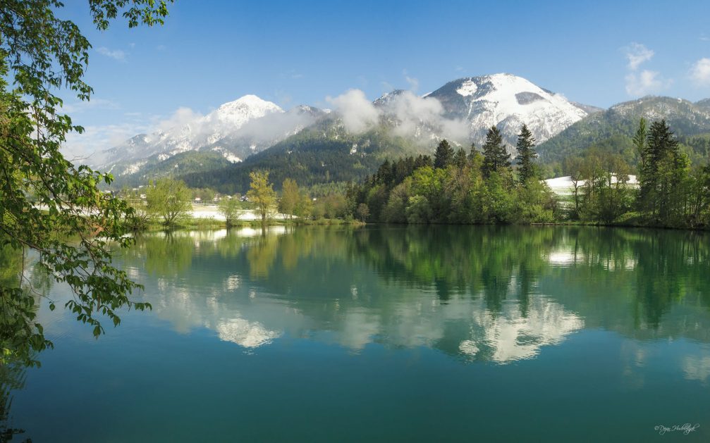 The dark green surface of the beautiful Lake Crnava in Preddvor in northwestern Slovenia