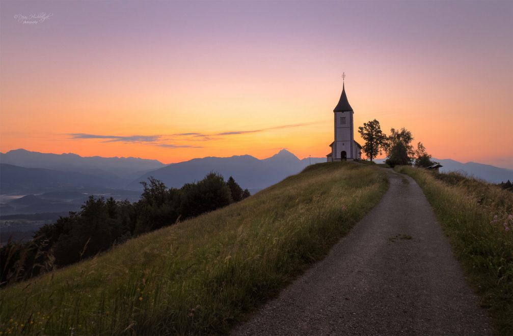 A dirt road leading to the Church of Saints Primus and Felician in Jamnik, Slovenia