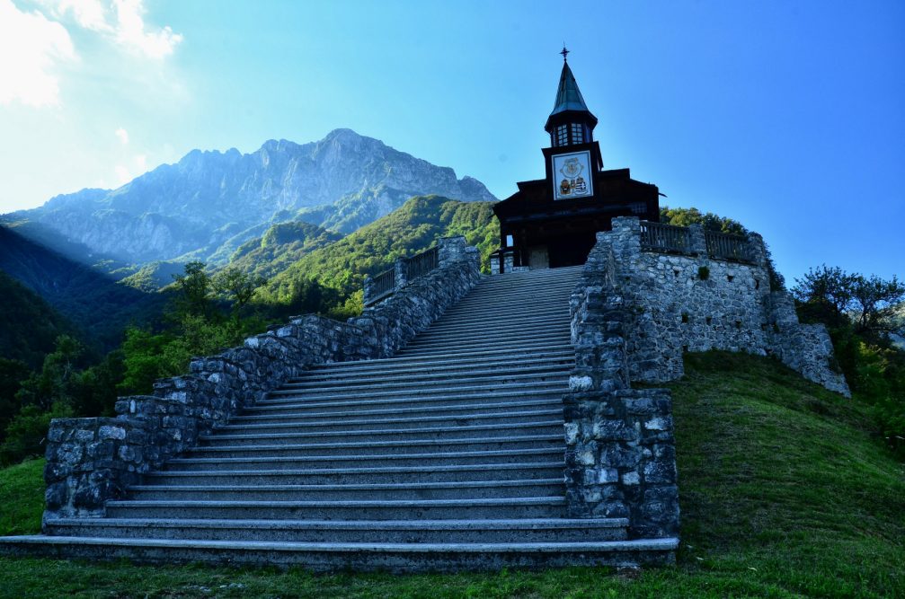 The Javorca Memorial Church of the Holy Spirit with the Julian Alps in the background