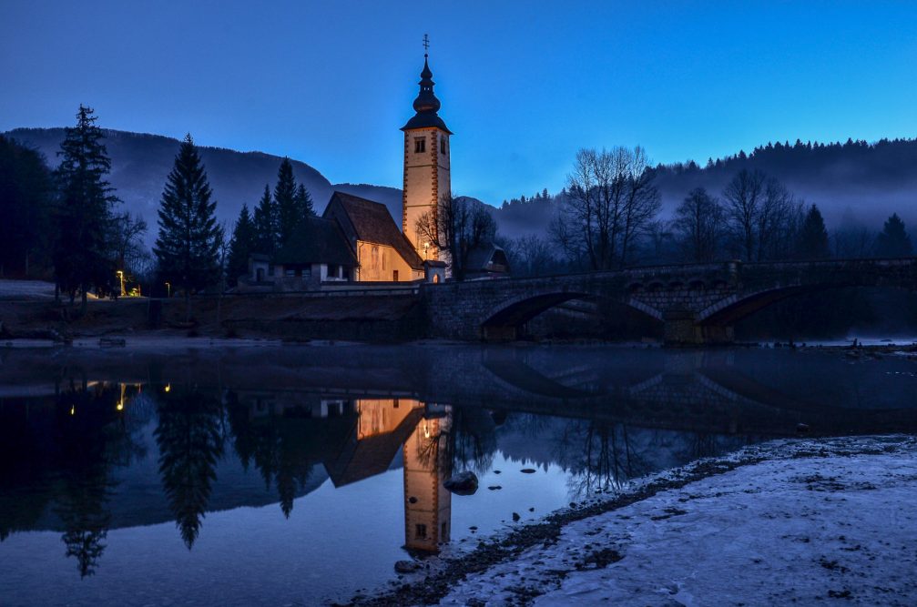 The Church of St. John the Baptist at Lake Bohinj, Slovenia illuminated at night