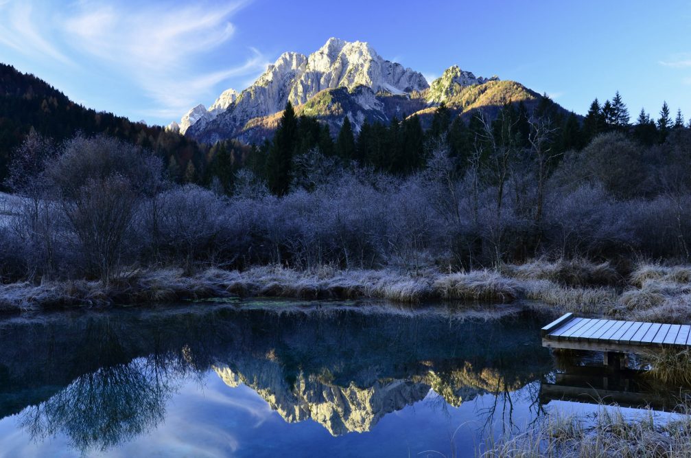 Lake Zelenci in the winter season with the Julian Alps in the background