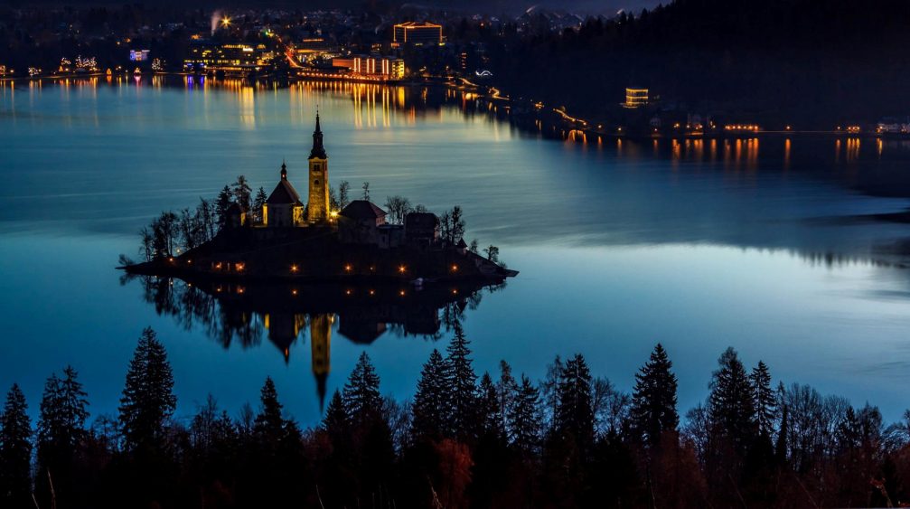 Elevated view of Lake Bled and its island by night