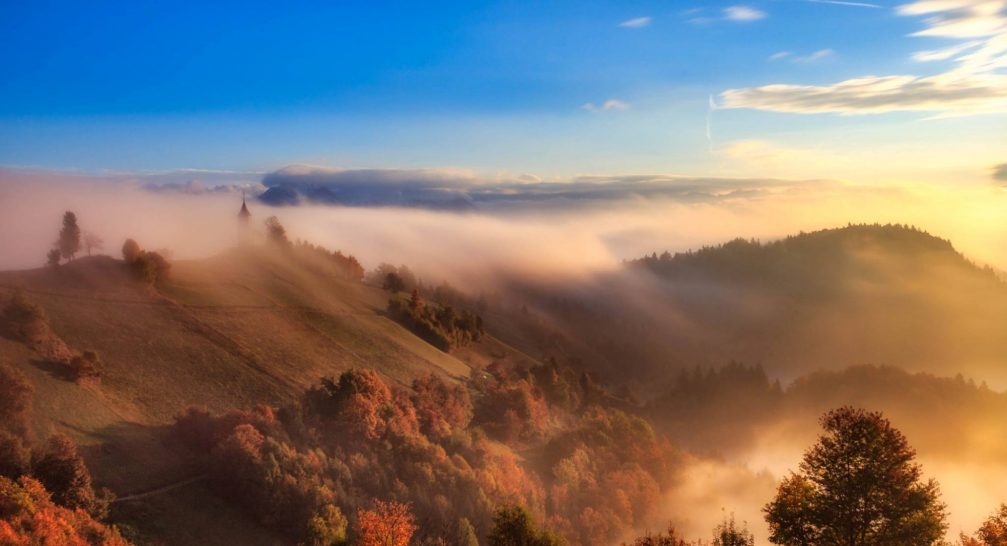 The hilltop Church of Saints Primus and Felician in Jamnik, Slovenia taken on a misty morning