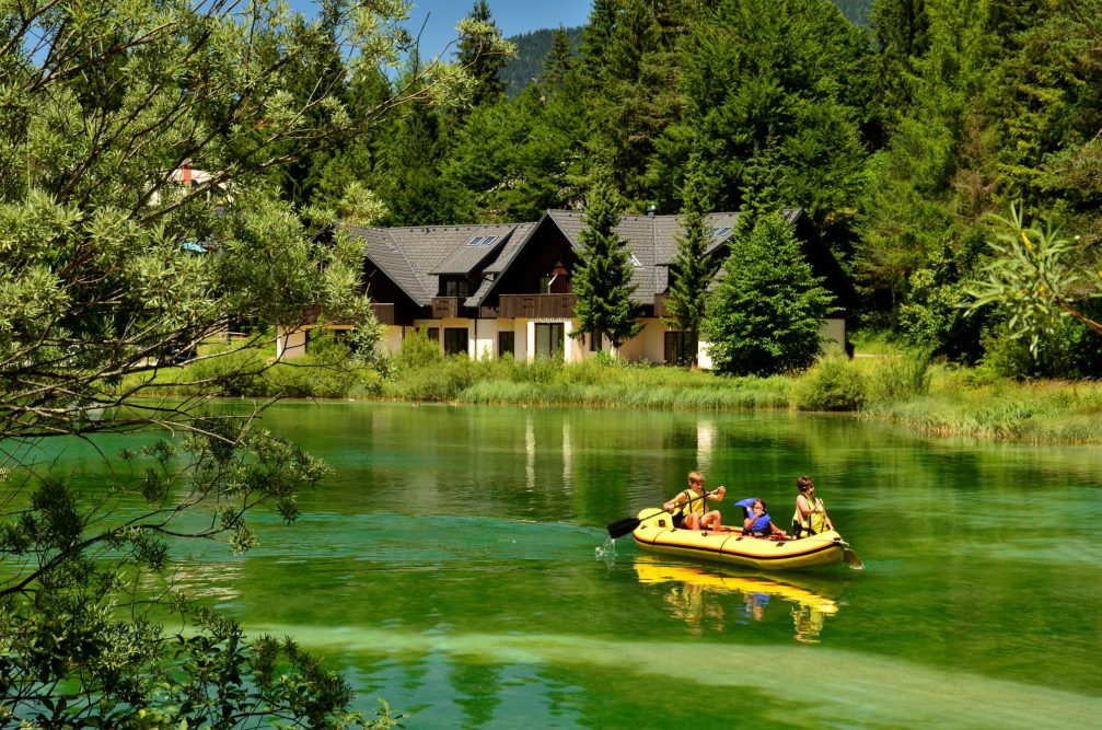 Rafting on a crystal clear and emerald lake Jasna in Kranjska Gora