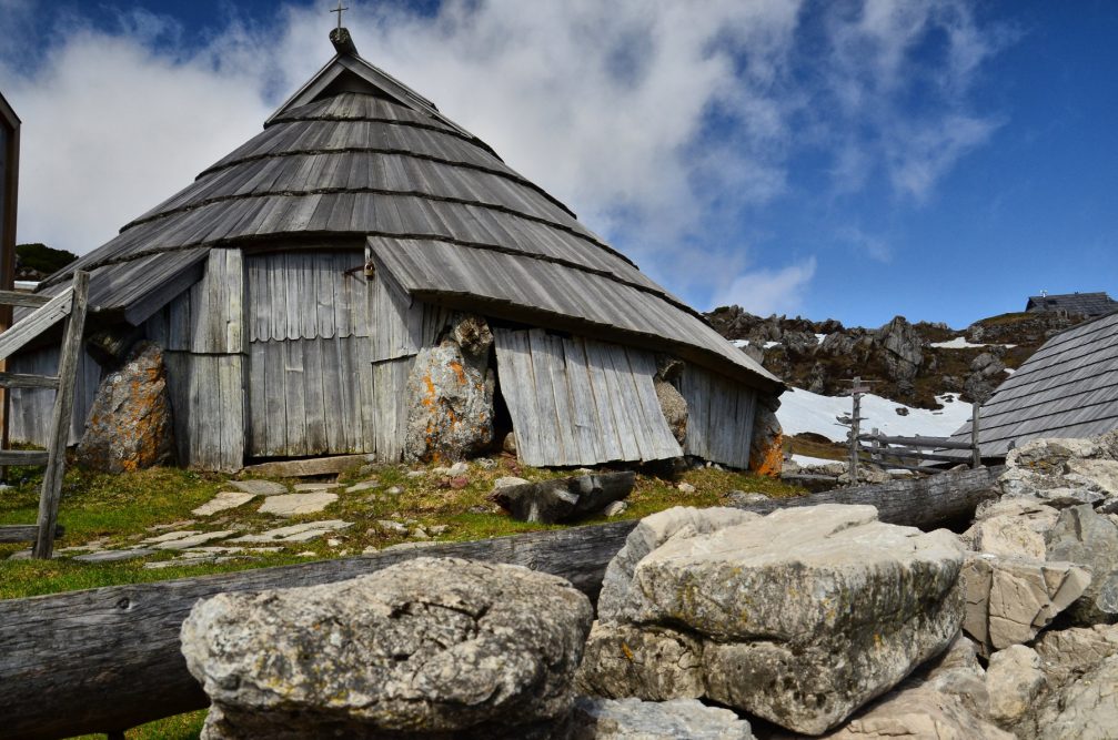 The low lying rounded shepherd's huts with conical roofs on the Velika Planina pasture