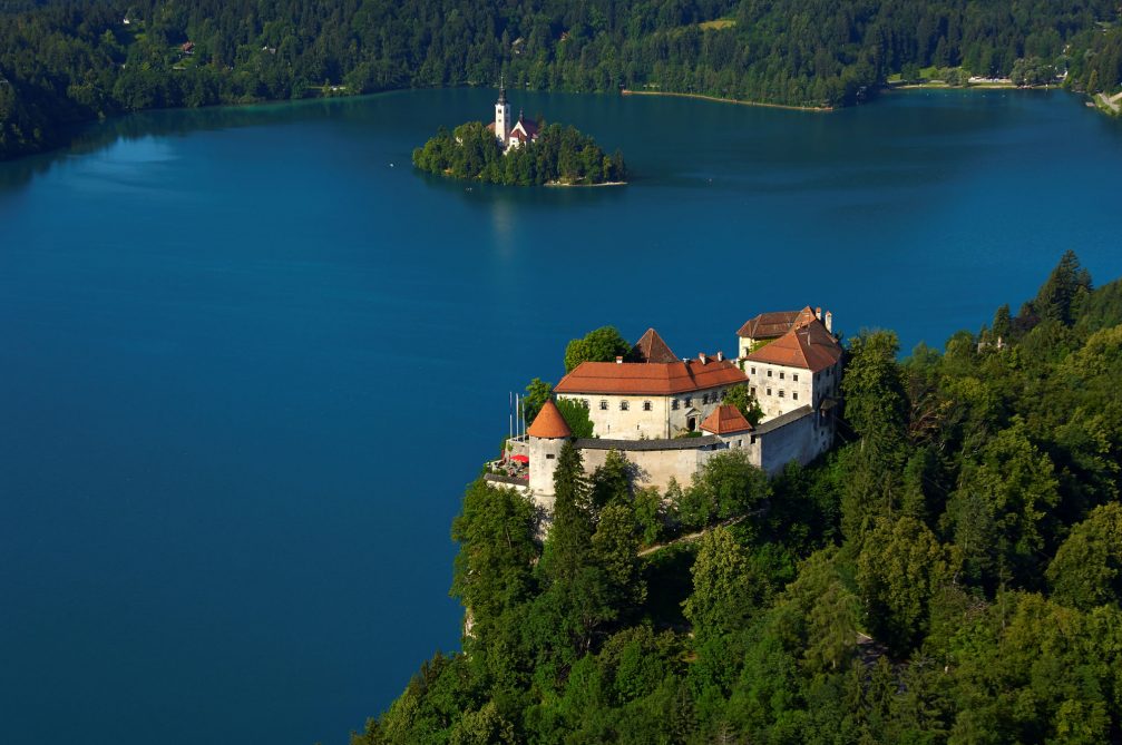 An aerial view of Lake Bled with its island and cliff-top castle