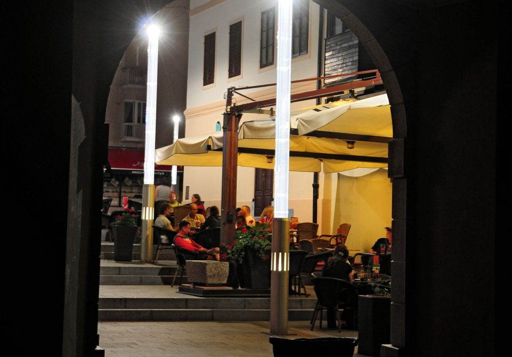 An outdoor cafe at night in the town center of Idrija, Slovenia