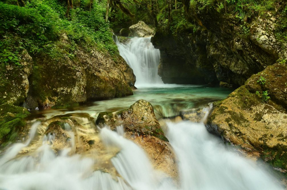 The fast-flowing Soca river with crystal-clear cold water in the Trenta Valley in Slovenia