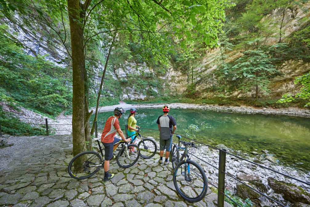 Three bikers at the Wild Lake in the Idrija area of Slovenia