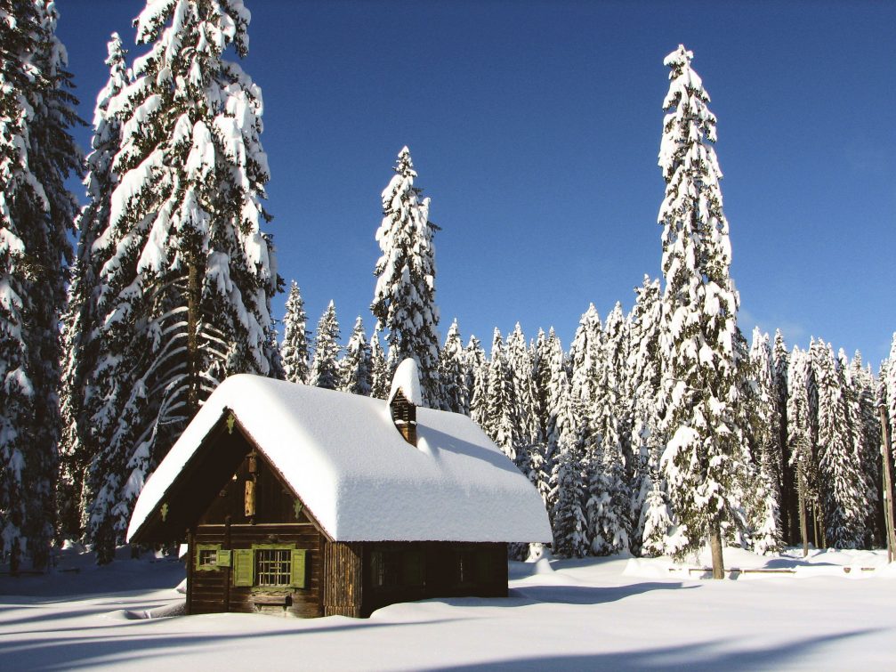 A lonely cottage at the Pokljuka Plateau covered with snow in the winter