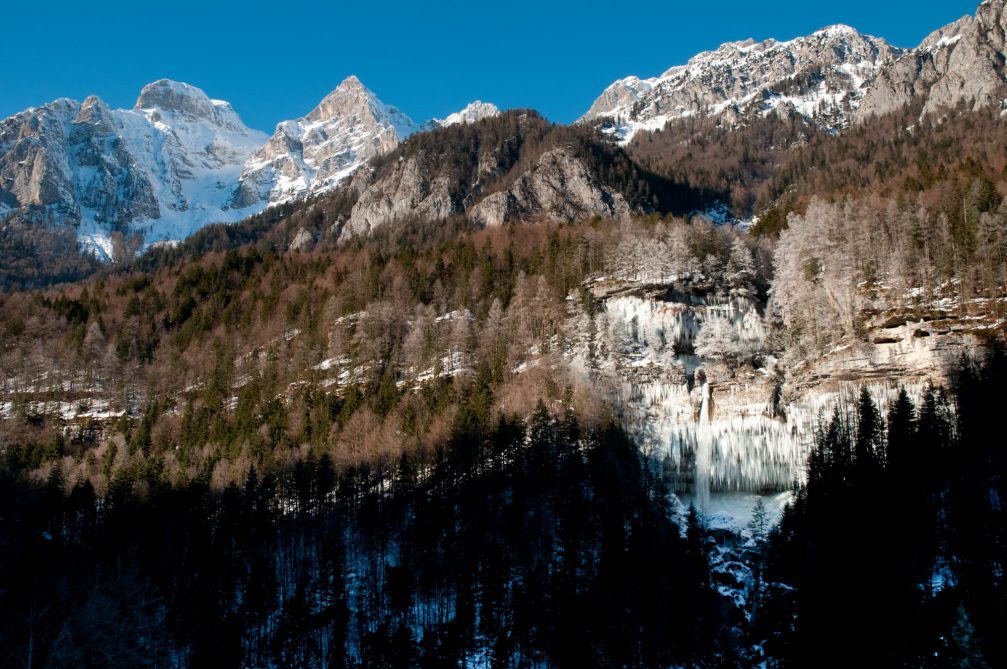 Waterfall Pericnik in Slovenia frozen into a wall of icicles in the winter