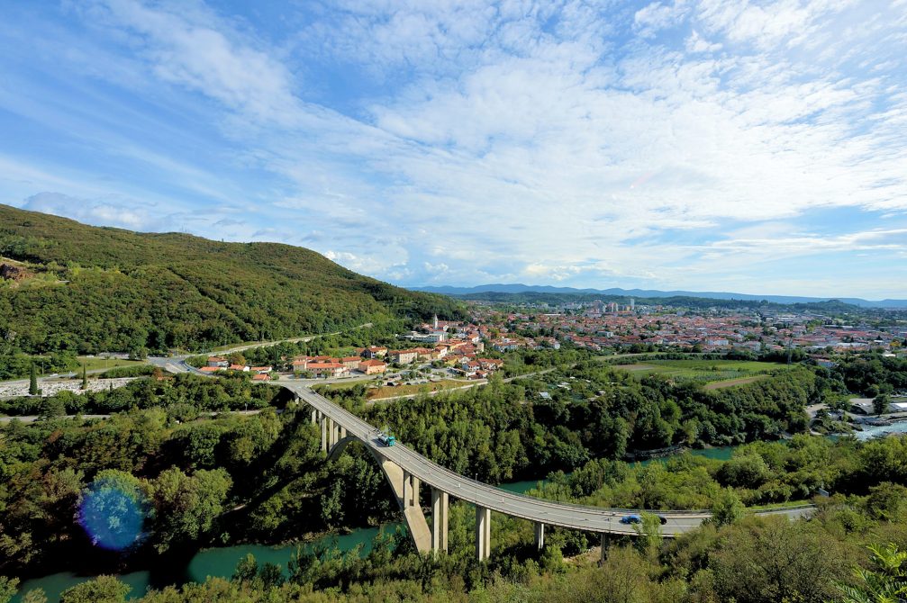 Road bridge across the Soca river with the town of Nova Gorica in the background