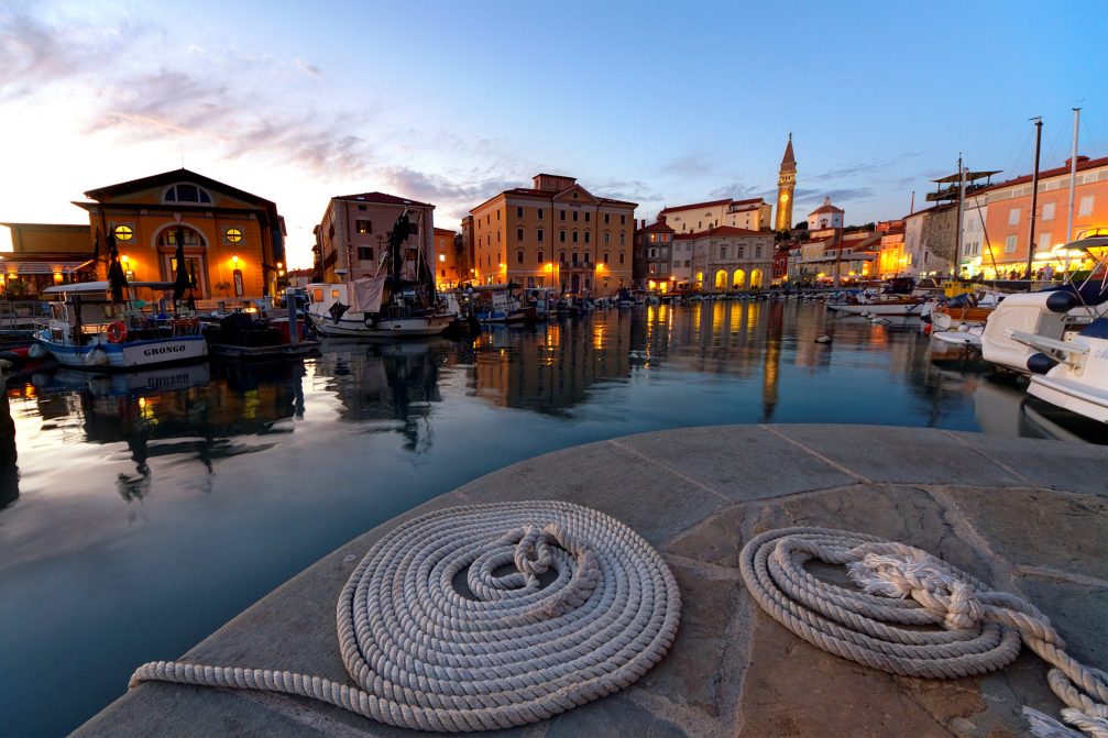 A view of Piran's bell tower from the harbour in the evening