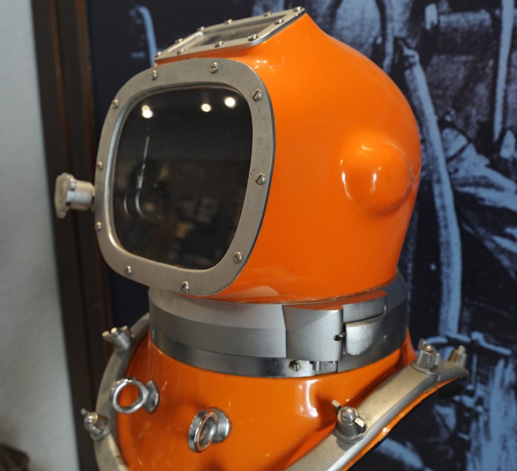 An old orange diving helmet on display at the Museum Of Underwater Activities Piran