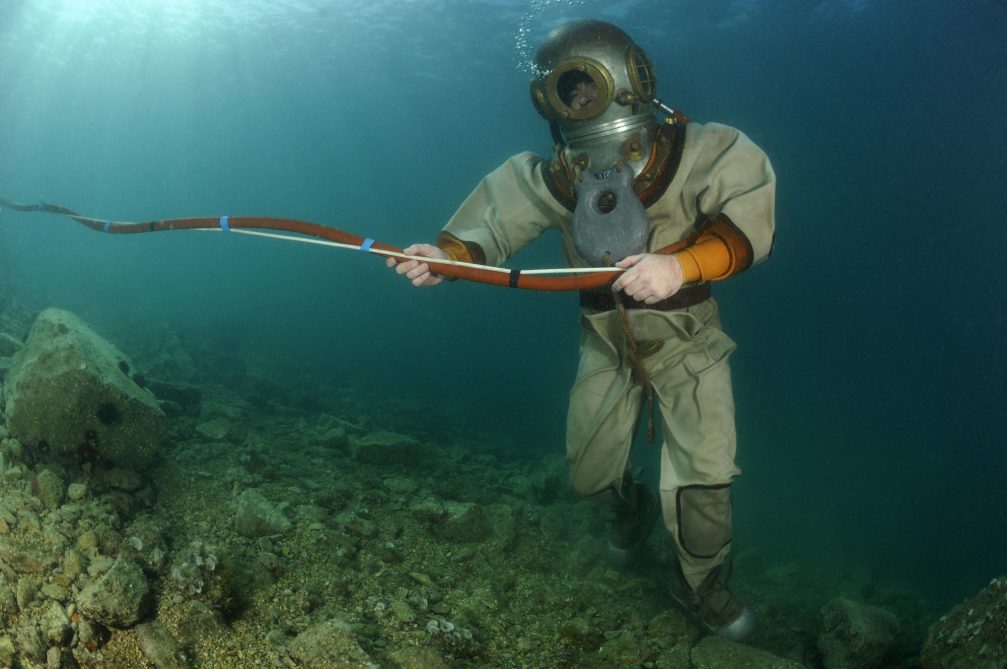 A diver wearing antique diving gear by Siebe Gorman