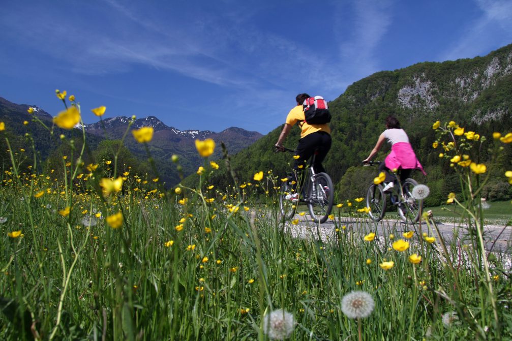 A couple cycling in the Gorenjska region of Slovenia in spring