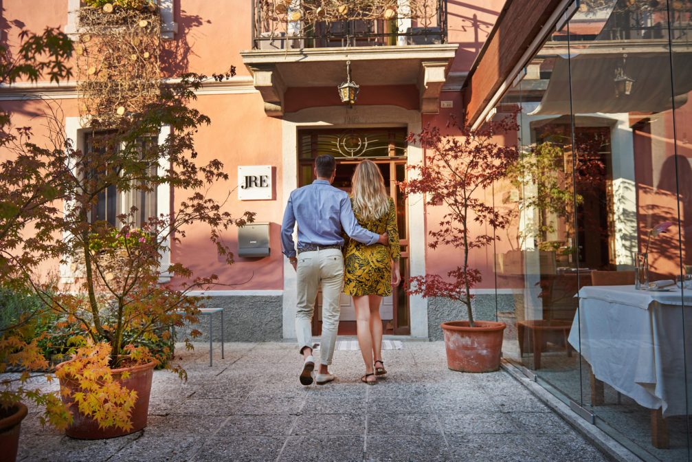 A young couple in front of the Hisa Franko restaurant in Kobarid, Slovenia