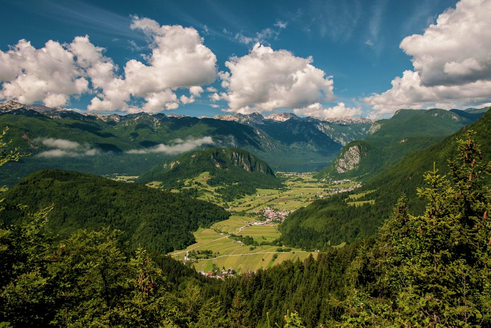 Elevated view of the Bohinj basin with several small villages and Lake Bohinj in the background