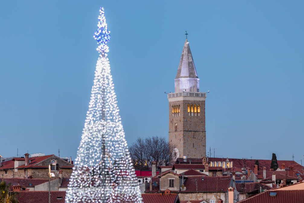 Koper Old Town with the Bell Tower and richly decorated Christmas tree in festive December