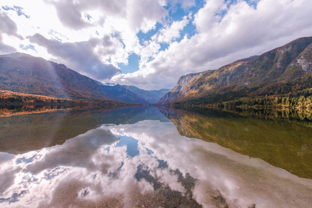 Fascinating reflections in Lake Bohinj in Slovenia on a cloudy autumn day